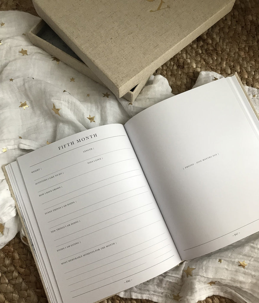 First year baby journal for recording memories and milestones, month by month 
